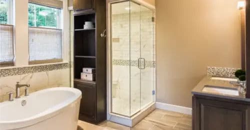 Modern bathroom featuring a freestanding tub, glass shower, and sleek cabinetry.